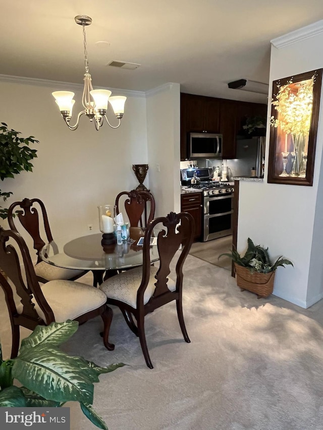 dining room with light carpet, a notable chandelier, visible vents, and ornamental molding