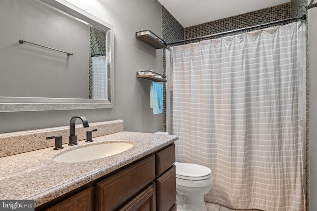 bathroom featuring vanity, toilet, and a shower with curtain