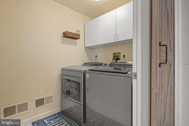 clothes washing area with baseboards, cabinet space, visible vents, and washing machine and clothes dryer