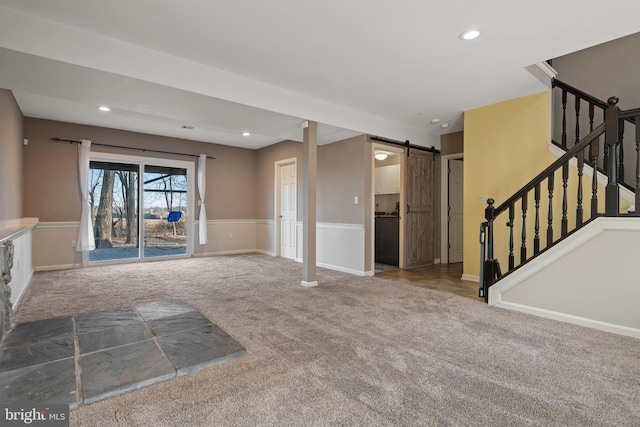 unfurnished living room featuring stairs, a barn door, recessed lighting, and carpet floors