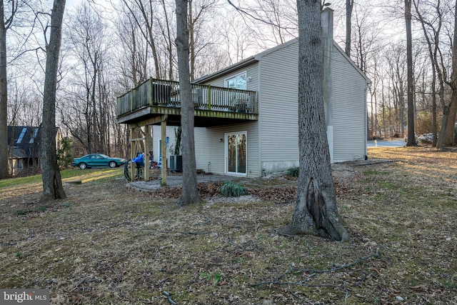 back of property featuring cooling unit and a deck