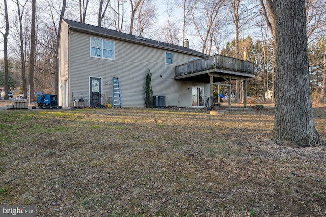 rear view of house with a deck, central air condition unit, and a chimney