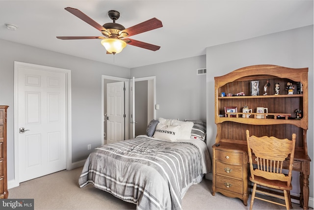 bedroom with light carpet, baseboards, visible vents, and a ceiling fan