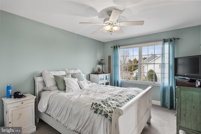 bedroom featuring a ceiling fan, light colored carpet, and baseboards