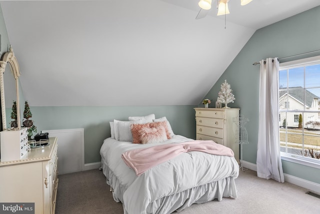 bedroom with light carpet, multiple windows, and baseboards