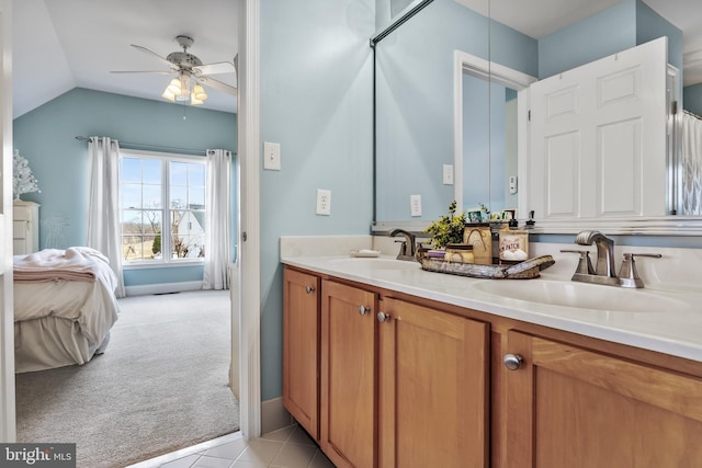 bathroom featuring double vanity, a ceiling fan, a sink, and ensuite bathroom