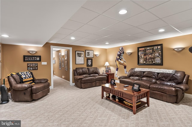 carpeted living room featuring a paneled ceiling, baseboards, and recessed lighting