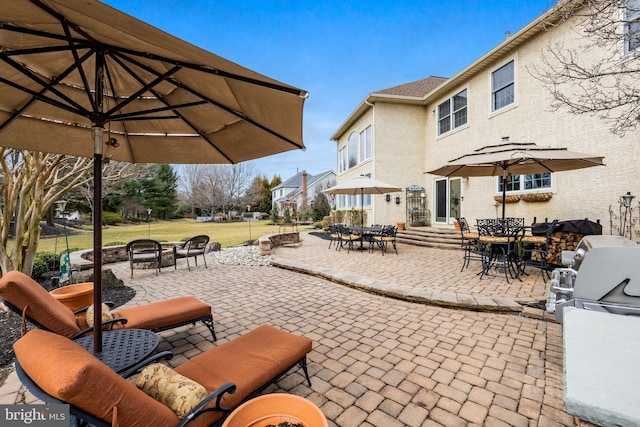 view of patio featuring a fire pit, outdoor dining area, and entry steps