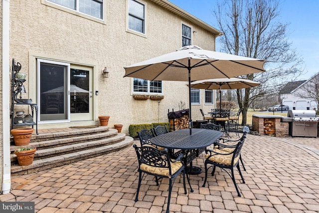 view of patio / terrace featuring entry steps, a grill, area for grilling, and outdoor dining space