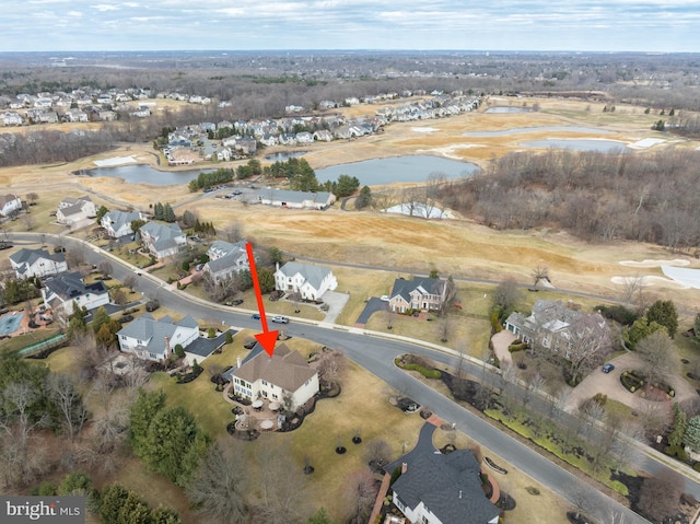 birds eye view of property with a water view and a residential view