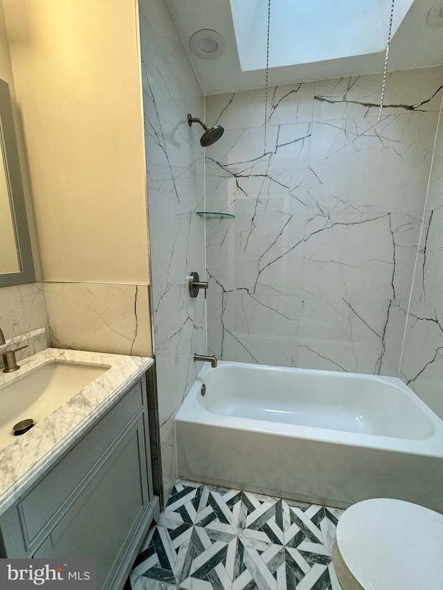 bathroom featuring vanity, toilet, and bathing tub / shower combination