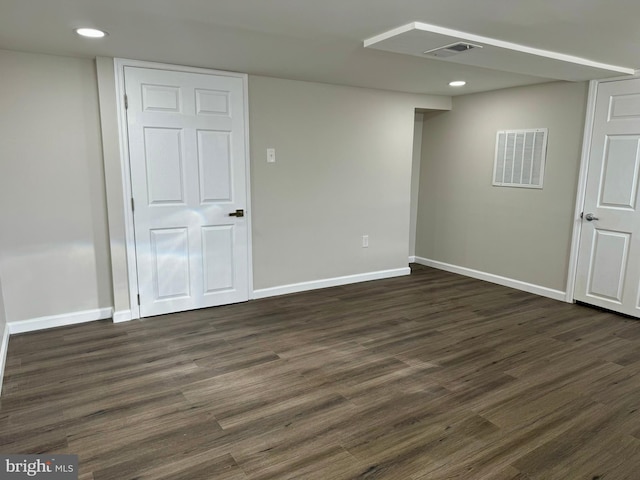 basement with baseboards, visible vents, dark wood-style flooring, and recessed lighting