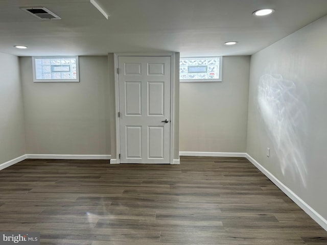 basement with baseboards, visible vents, dark wood-style flooring, and recessed lighting