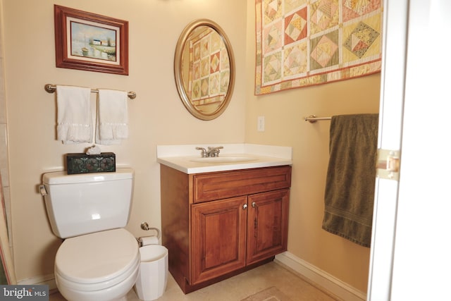 bathroom with toilet, baseboards, and vanity