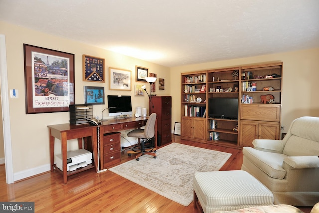 office area with light wood-type flooring and baseboards