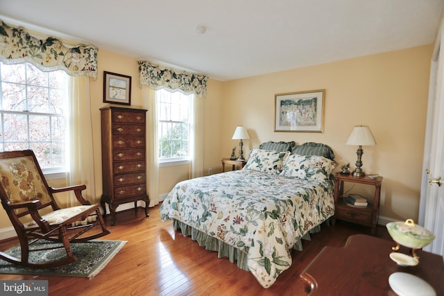 bedroom featuring wood finished floors and baseboards