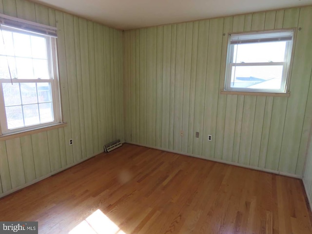 empty room featuring light wood-type flooring and visible vents