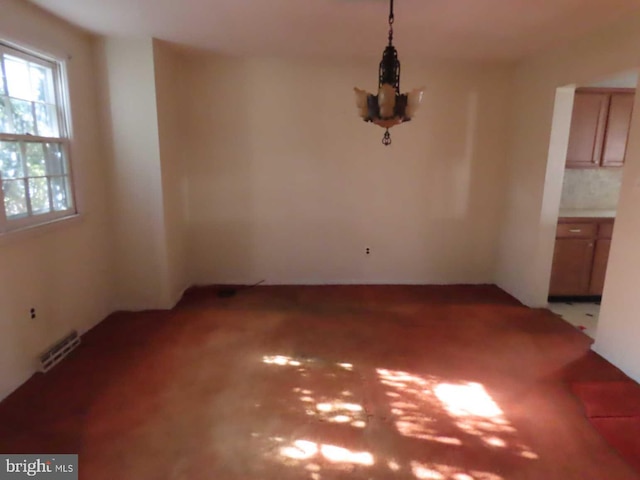 unfurnished dining area featuring visible vents