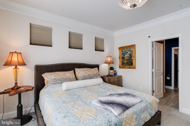 carpeted bedroom featuring baseboards and crown molding