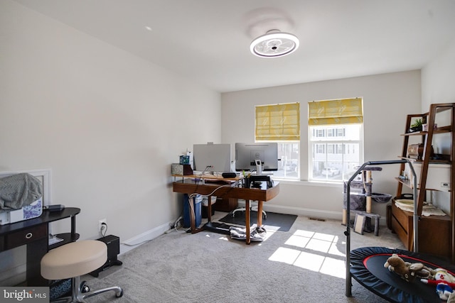 home office featuring carpet and baseboards