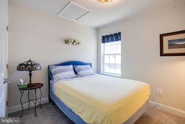 carpeted bedroom featuring attic access and baseboards