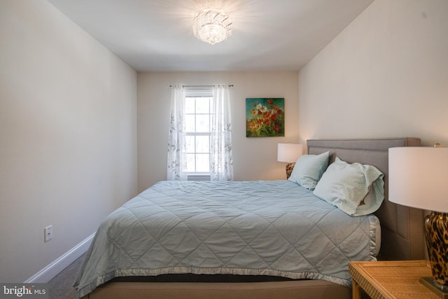 carpeted bedroom featuring baseboards