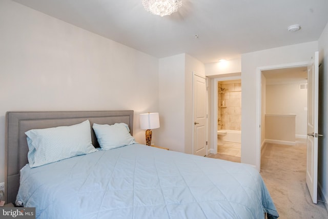 bedroom with carpet flooring, connected bathroom, and baseboards