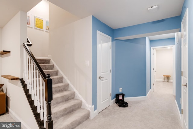 stairway with carpet floors and baseboards