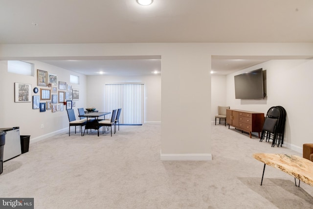 dining room featuring carpet and baseboards