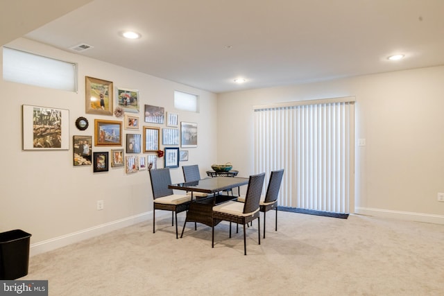 dining room with recessed lighting, light colored carpet, and baseboards