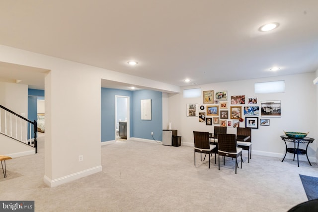 carpeted dining space featuring stairs, baseboards, and recessed lighting