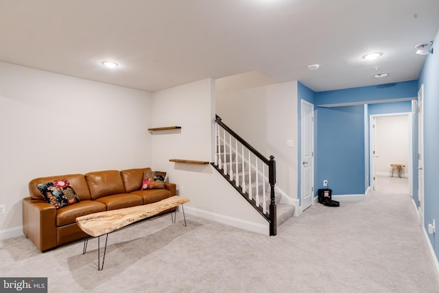 living room featuring carpet, stairs, and baseboards