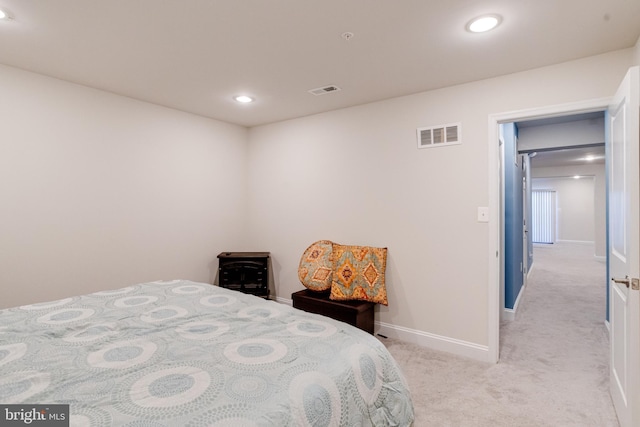 bedroom with light carpet, recessed lighting, visible vents, and baseboards