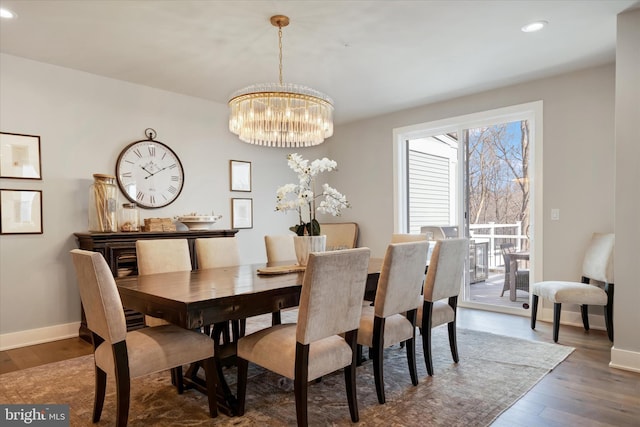 dining area featuring dark wood-style floors, baseboards, a chandelier, and recessed lighting