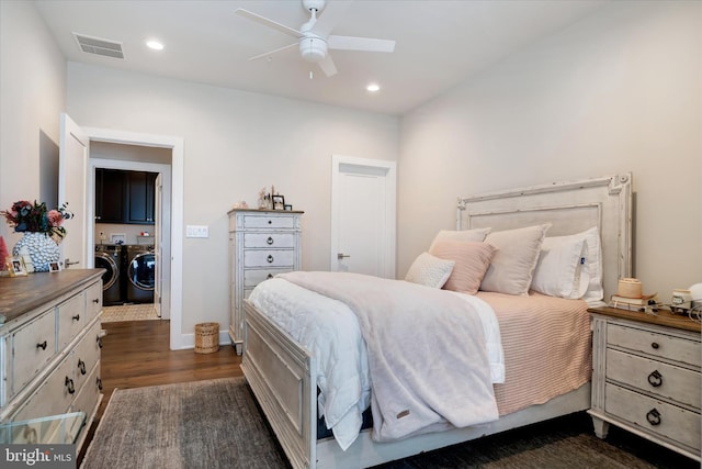 bedroom with dark wood finished floors, recessed lighting, visible vents, washer and dryer, and baseboards