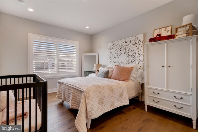 bedroom featuring hardwood / wood-style flooring and recessed lighting