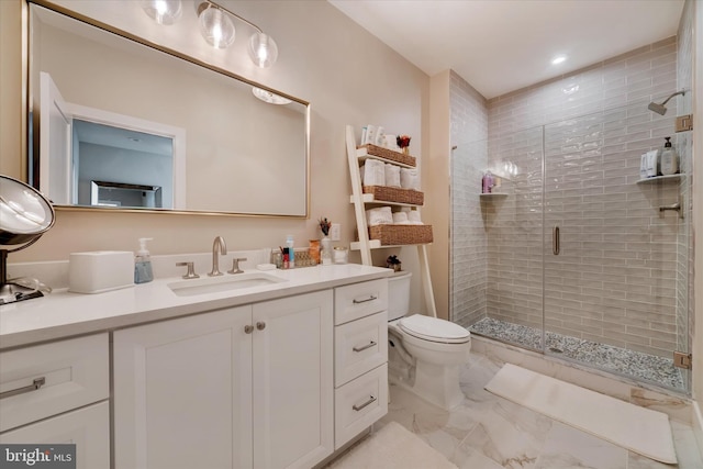 bathroom with marble finish floor, a stall shower, vanity, and toilet