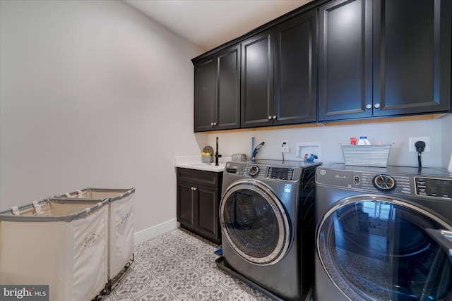 washroom featuring light tile patterned flooring, cabinet space, a sink, and separate washer and dryer