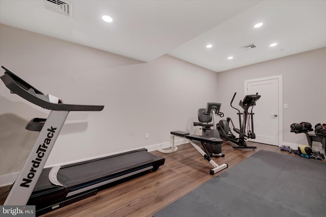 workout room with recessed lighting, visible vents, and wood finished floors