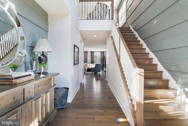 foyer featuring dark wood finished floors, recessed lighting, visible vents, baseboards, and stairs