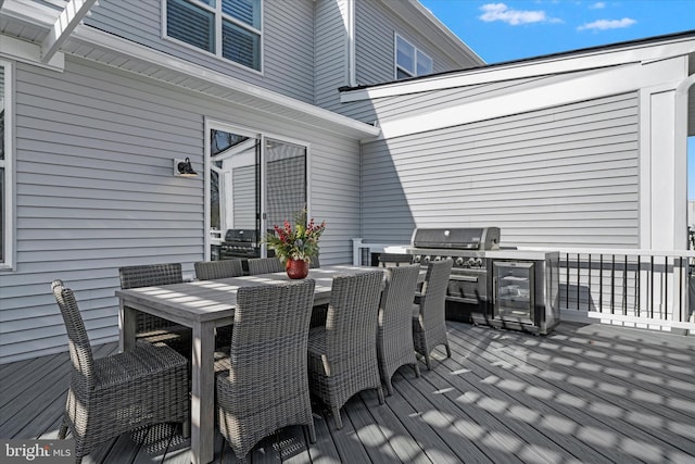 deck featuring outdoor dining space and wine cooler