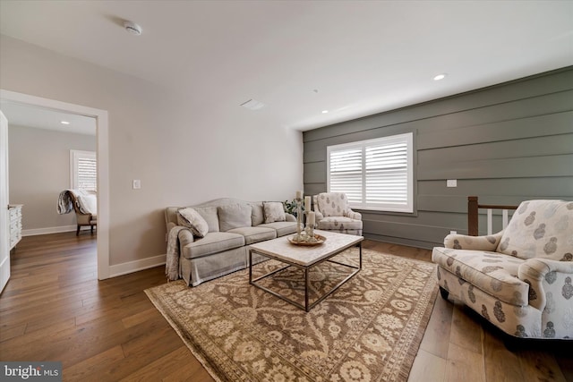 living room featuring hardwood / wood-style floors, recessed lighting, a wealth of natural light, and baseboards