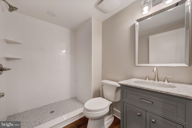 full bathroom with toilet, wood finished floors, a shower stall, and vanity