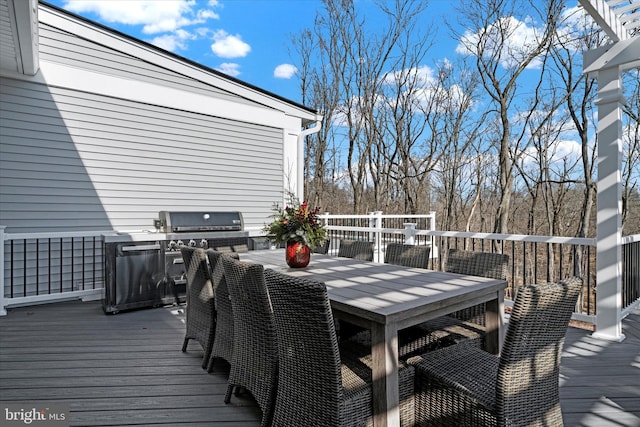 wooden deck featuring outdoor dining area and area for grilling