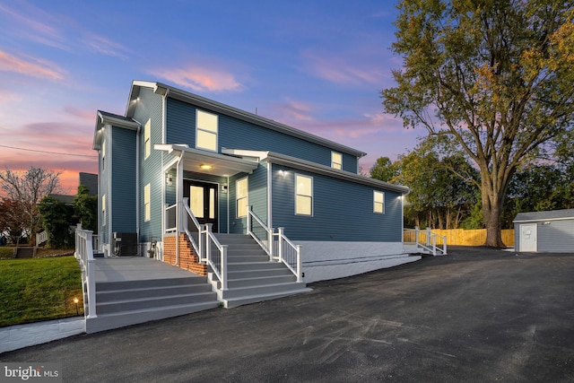 view of front of house with a shed and an outdoor structure