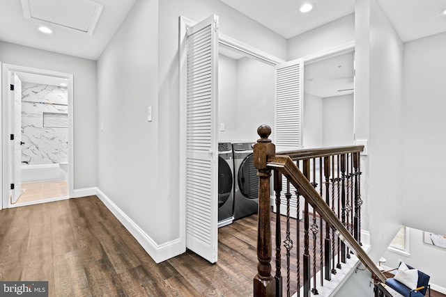 hall featuring dark wood-type flooring, an upstairs landing, baseboards, washer and dryer, and attic access