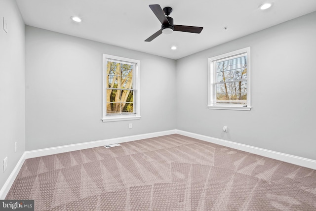 carpeted spare room featuring visible vents, baseboards, a ceiling fan, and recessed lighting