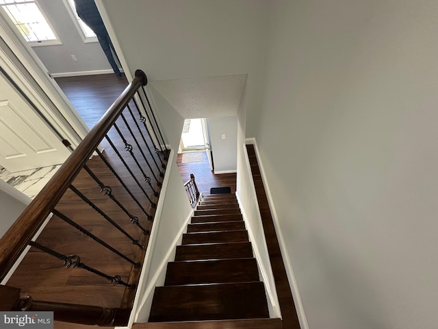 stairs featuring baseboards and wood finished floors