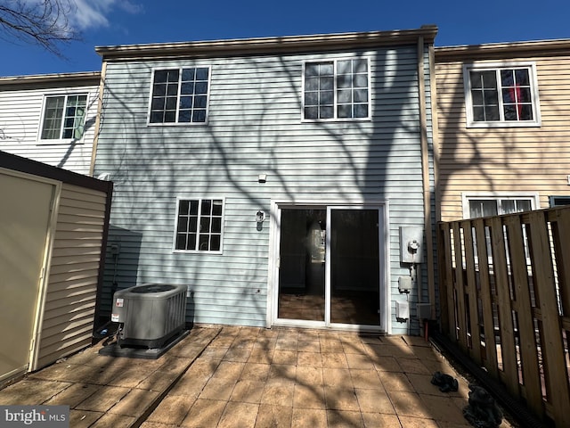 back of house with a deck and cooling unit