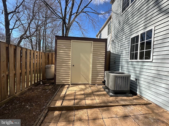 view of shed featuring a fenced backyard and central air condition unit